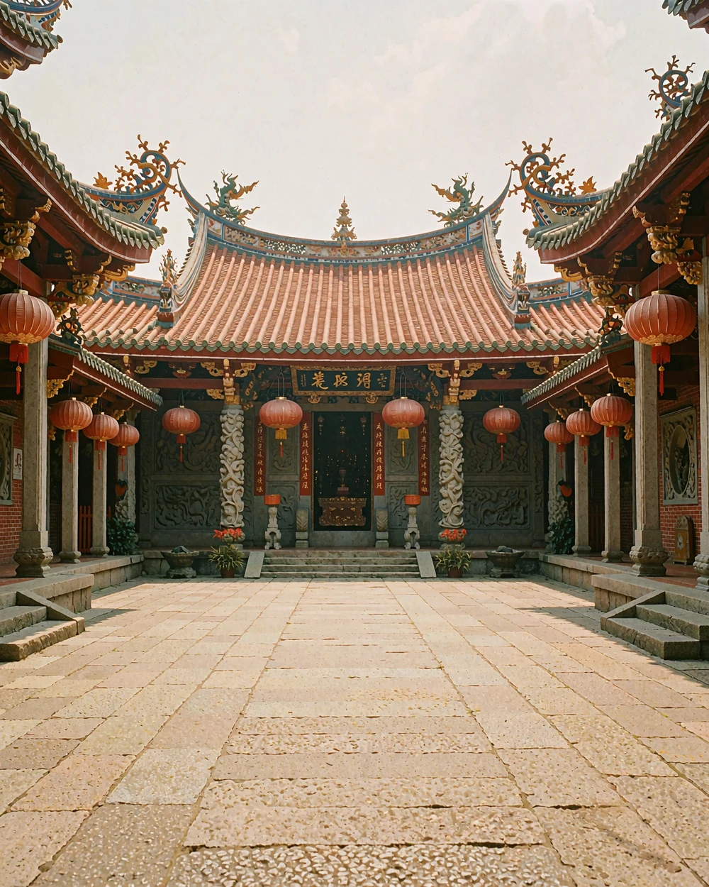 Traditional Taiwanese temple courtyard with tiled roofs and a quiet stone forecourt